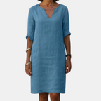 Front view of the Adele Shift Dress Lightweight V-Neck Half-Sleeve in blue, featuring a V-neckline, half sleeves, side pockets, and a relaxed shift silhouette for effortless everyday wear. Designed by Bella Hudson.