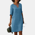 Front detail view of the Adele Shift Dress Lightweight V-Neck Half-Sleeve in blue, showcasing the V-neckline, half sleeves, practical side pockets, and relaxed everyday silhouette. Designed by Bella Hudson.