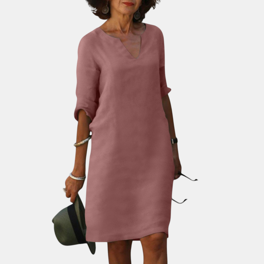 Front view of the Adele Shift Dress Lightweight V-Neck Half-Sleeve in dark pink, featuring a V-neckline, half sleeves, side pockets, and a relaxed knee-length silhouette. Designed by Bella Hudson.