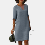 Front view of the Adele Shift Dress Lightweight V-Neck Half-Sleeve in gray, featuring a V-neckline, half sleeves, side pockets, and a comfortable knee-length design. Designed by Bella Hudson.