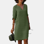 Front view of the Adele Shift Dress Lightweight V-Neck Half-Sleeve in green, featuring a V-neckline, half sleeves, side pockets, and a lightweight shift silhouette. Designed by Bella Hudson.