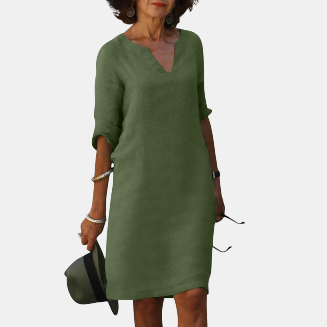 Front view of the Adele Shift Dress Lightweight V-Neck Half-Sleeve in green, featuring a V-neckline, half sleeves, side pockets, and a lightweight shift silhouette. Designed by Bella Hudson.