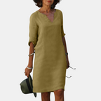 Front view of the Adele Shift Dress Lightweight V-Neck Half-Sleeve in khaki, featuring a V-neckline, half sleeves, side pockets, and a relaxed shift silhouette. Designed by Bella Hudson.