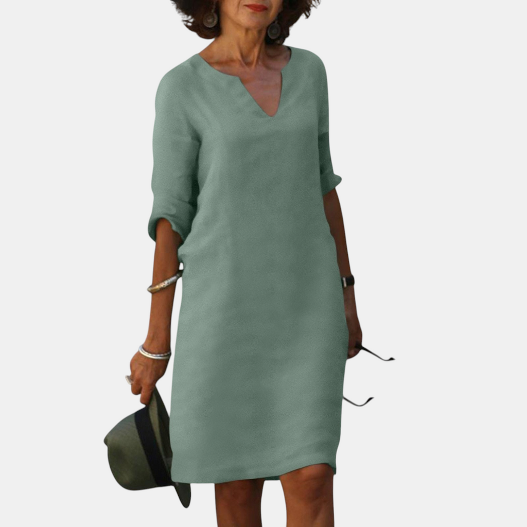 Front view of the Adele Shift Dress Lightweight V-Neck Half-Sleeve in light green, featuring a V-neckline, half sleeves, side pockets, and a relaxed everyday fit. Designed by Bella Hudson.