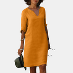 Front view of the Adele Shift Dress Lightweight V-Neck Half-Sleeve in orange, featuring a V-neckline, half sleeves, side pockets, and a lightweight relaxed fit. Designed by Bella Hudson.