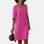 Front view of the Adele Shift Dress Lightweight V-Neck Half-Sleeve in pink, featuring a V-neckline, half sleeves, side pockets, and a flattering shift silhouette. Designed by Bella Hudson.