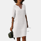 Front view of the Adele Shift Dress Lightweight V-Neck Half-Sleeve in white, featuring a V-neckline, half sleeves, side pockets, and a timeless relaxed silhouette. Designed by Bella Hudson.