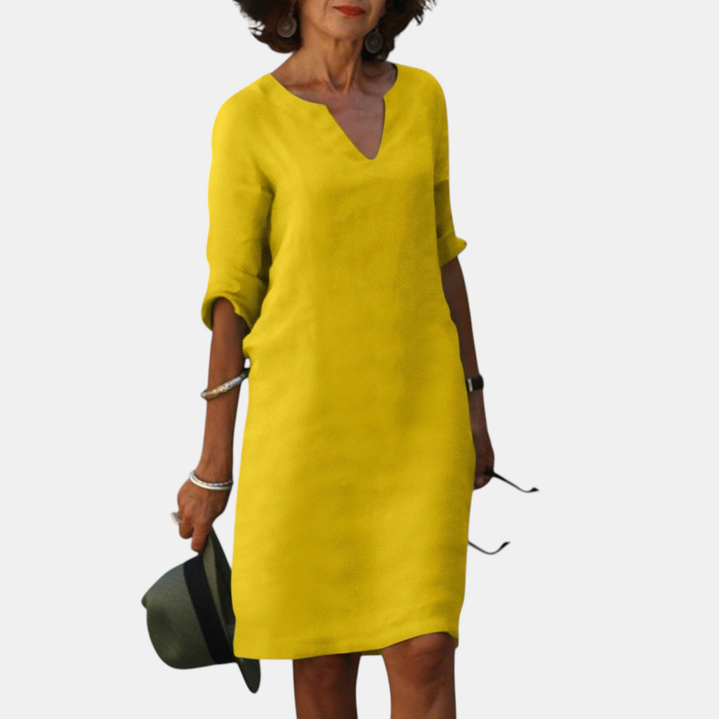 Front view of the Adele Shift Dress Lightweight V-Neck Half-Sleeve in yellow, featuring a V-neckline, half sleeves, side pockets, and a bright casual silhouette. Designed by Bella Hudson.