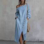 Adeline Light Blue denim maxi dress with asymmetric off-shoulder neckline, diagonal button detailing, long sleeves, and front slit