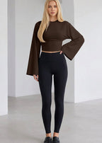 Alina Brown ruched-waist top close-up highlighting the fitted waist, crew neckline, and long flared sleeves