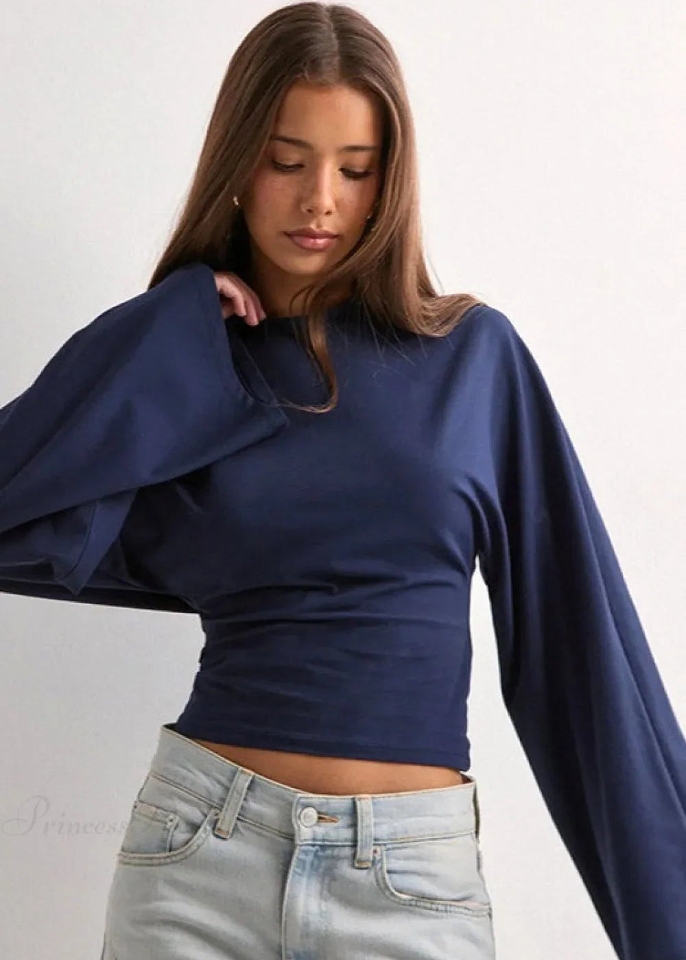 Alina Navy Blue top showing the fitted ruched waist and wide sleeves, paired with light blue jeans.