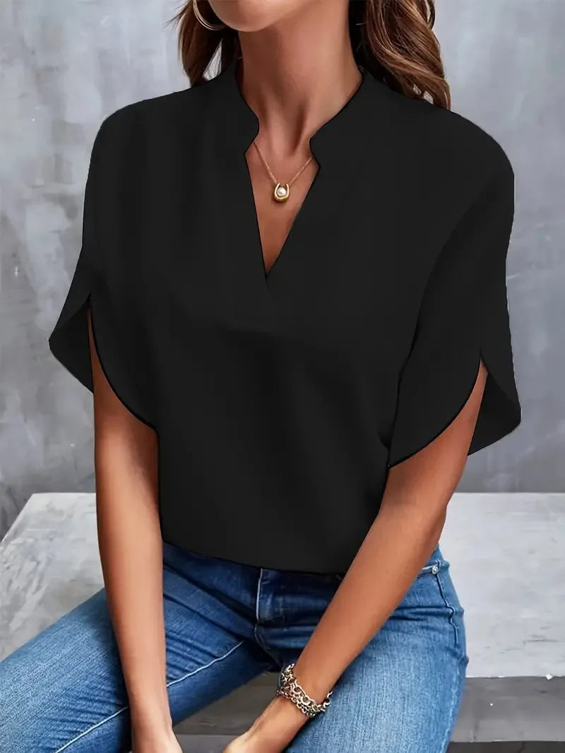 Front view of the Amandine Blouse V-Neck Flowy Short-Sleeve in black, featuring a split V-neckline, flowy short sleeves, and a relaxed everyday fit. Designed by Bella Hudson.