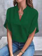Front view of the Amandine Blouse V-Neck Flowy Short-Sleeve in green, featuring a split V-neckline, flowy short sleeves, and a relaxed lightweight silhouette. Designed by Bella Hudson.