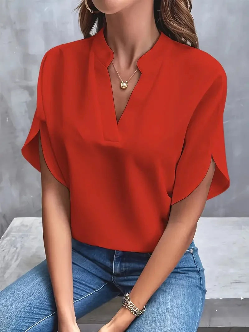 Front view of the Amandine Blouse V-Neck Flowy Short-Sleeve in red, featuring a split V-neckline, flowy short sleeves, and a relaxed draped silhouette. Designed by Bella Hudson.
