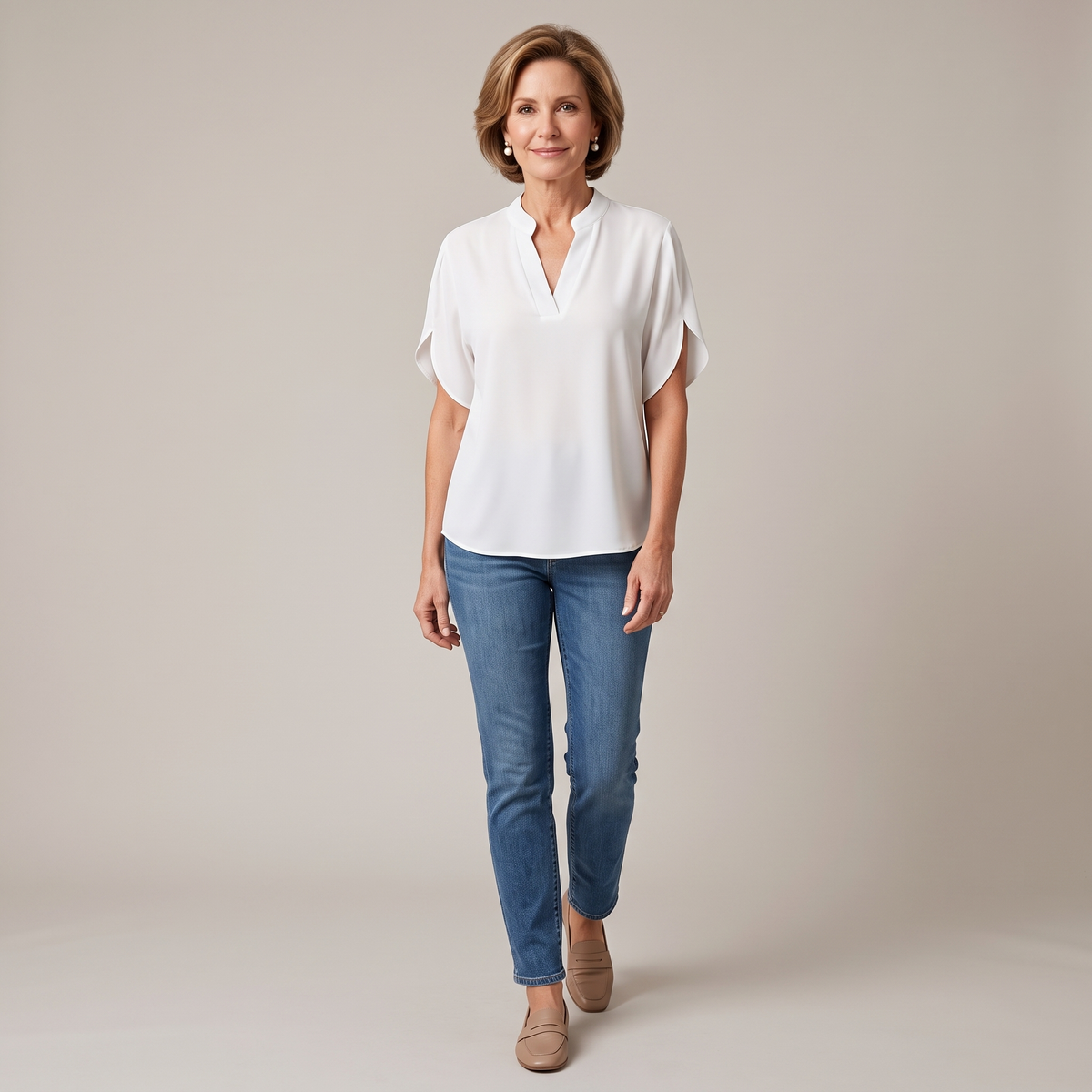 Front view of the Amandine Blouse V-Neck Flowy Short-Sleeve in white, featuring a split V-neckline, flowy short sleeves, lightweight fabric, and a relaxed everyday silhouette. Designed by Bella Hudson.