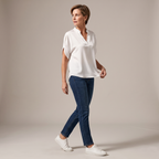 Side view of the Amandine Blouse V-Neck Flowy Short-Sleeve in white, showcasing the relaxed fit, flowy short sleeves, split V-neckline, and lightweight drape. Designed by Bella Hudson.