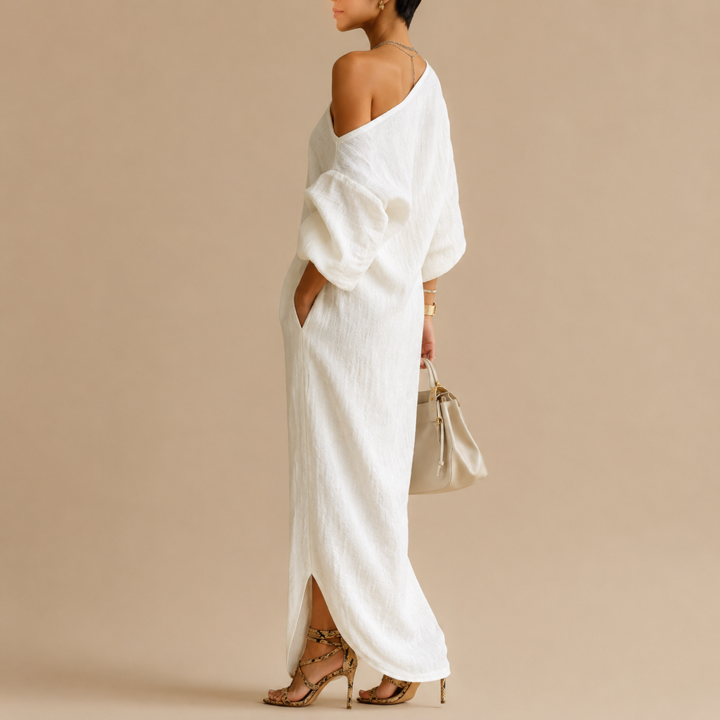 Side view of the Amara Maxi Dress One-Shoulder Linen in white featuring an elegant one-shoulder neckline, relaxed silhouette, and textured linen fabric, designed by Bella Hudson.