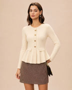 Amelia Beige peplum cardigan with gold bow-shaped buttons and flap pockets, styled with a brown gingham mini skirt.