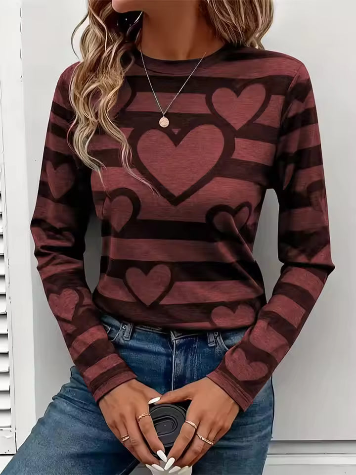 Amelia Brown striped T-shirt featuring layered heart graphics, long sleeves, and a classic crew neckline