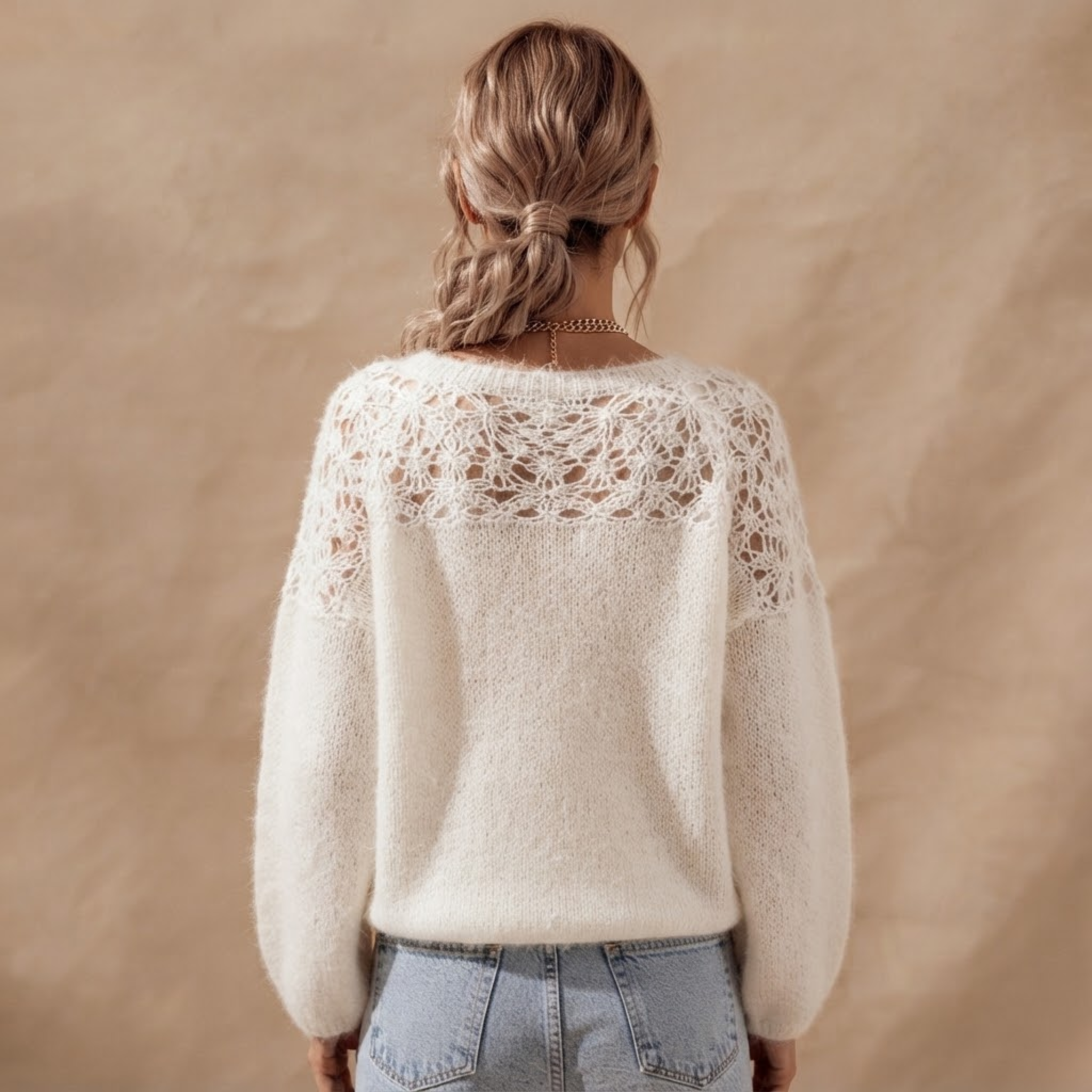 Back view of the Anouk Sweater Open-Knit Lace-Sleeve in White, highlighting the open-knit texture and relaxed silhouette.
