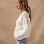 Side view of the Anouk Sweater Open-Knit Lace-Sleeve in White, showcasing its relaxed fit and textured knit design.