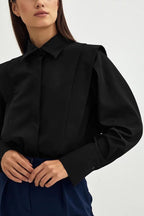Ariana Black button-down shirt close-up of the pleated shoulder detail and wide buttoned cuff.