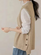 Audrey Beige knit sweater vest with sleeveless design, ribbed hem, and decorative side buttons