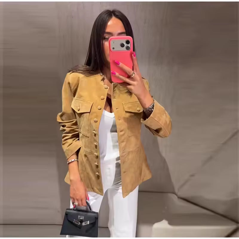 Audrey Brown faux-leather jacket with stand collar, covered buttons, flap chest pockets, structured shoulders, and long sleeves