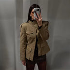 Audrey Khaki stand-collar jacket featuring covered front buttons, flap chest pockets, structured shoulders, and long sleeves