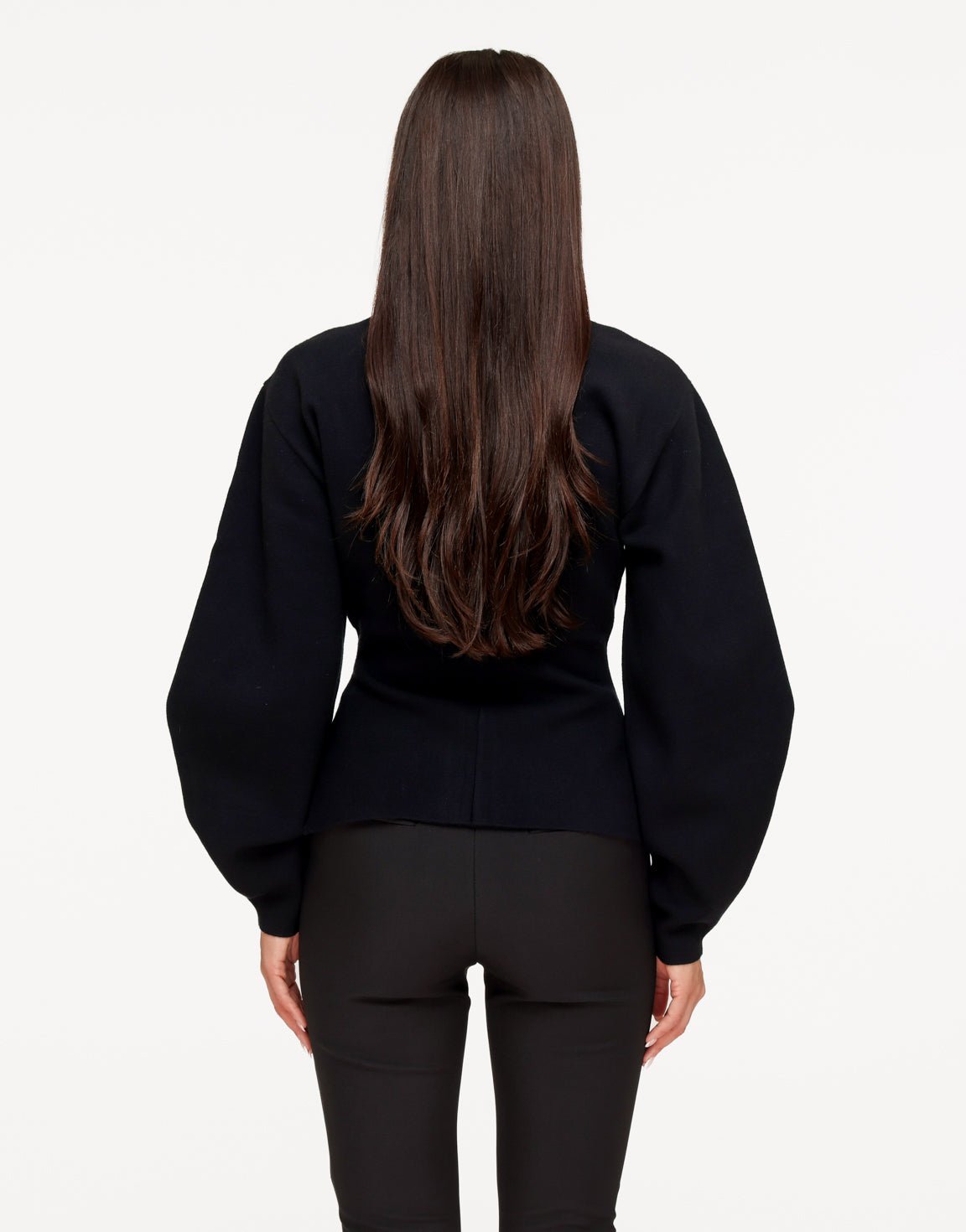 Aurelia Black cardigan from the back showing the balloon sleeves and fitted waist.