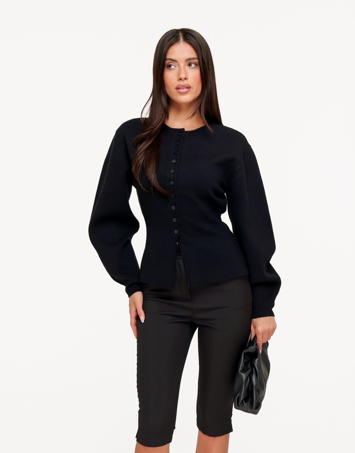 Aurelia Black button-front cardigan from the front on a white background with black capri pants and a black clutch.