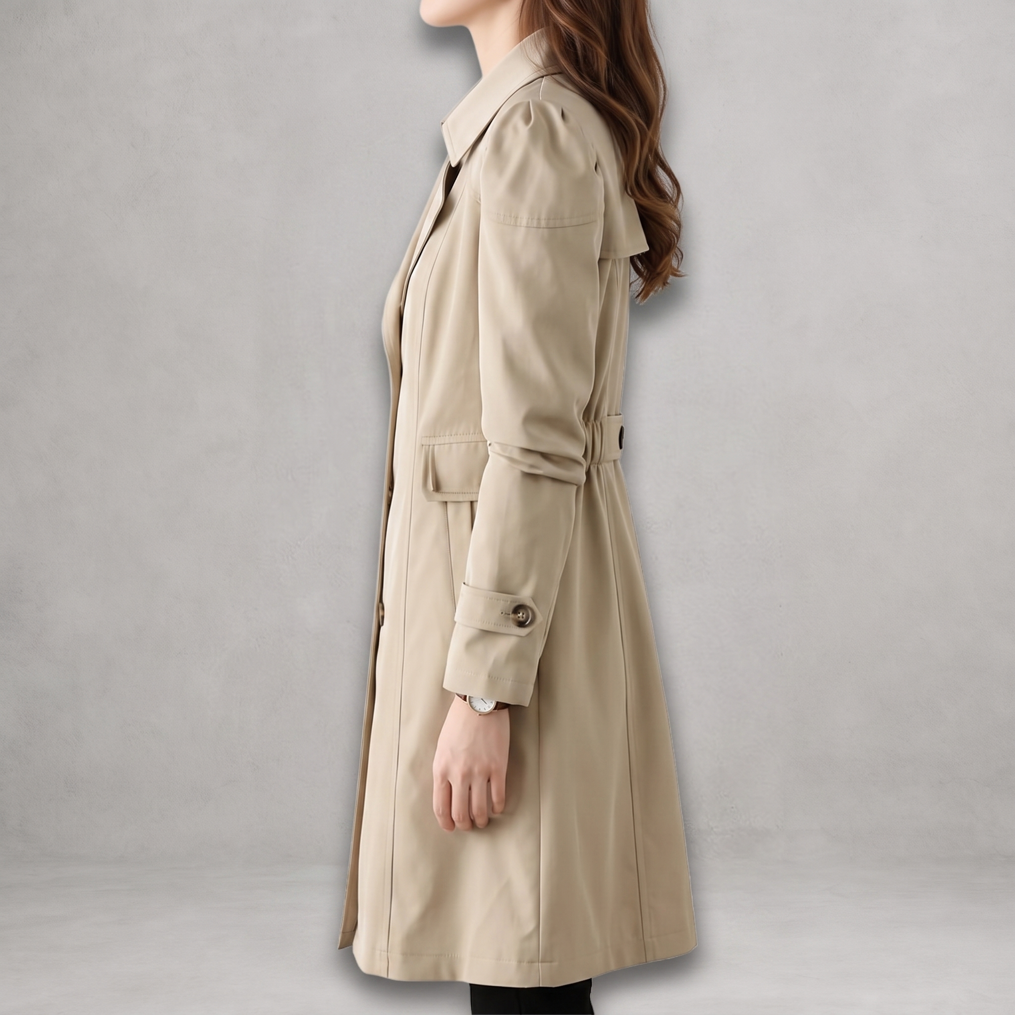 Side view of the Aurora Trench Coat with Belted Notch Collar in khaki, showcasing the notched lapel collar, long sleeves, side pocket, belted waist, and mid-length silhouette. Designed by Bella Hudson.