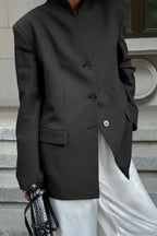 Aveline Black blazer close-up of the button front, flap pocket, and structured shoulder.