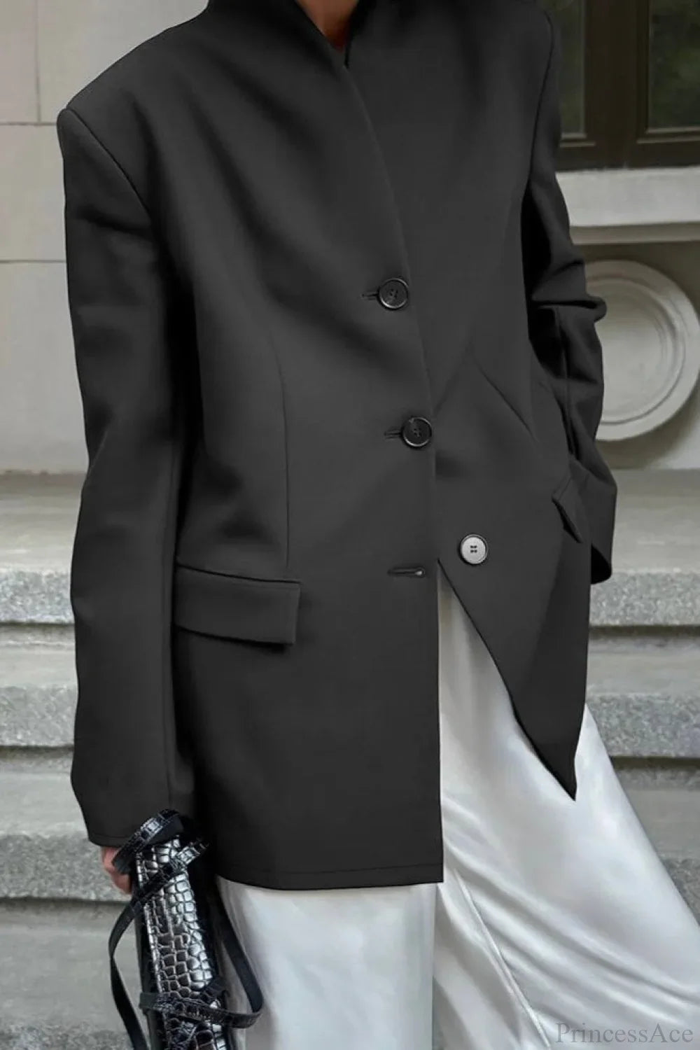 Aveline Black blazer close-up of the button front, flap pocket, and structured shoulder.
