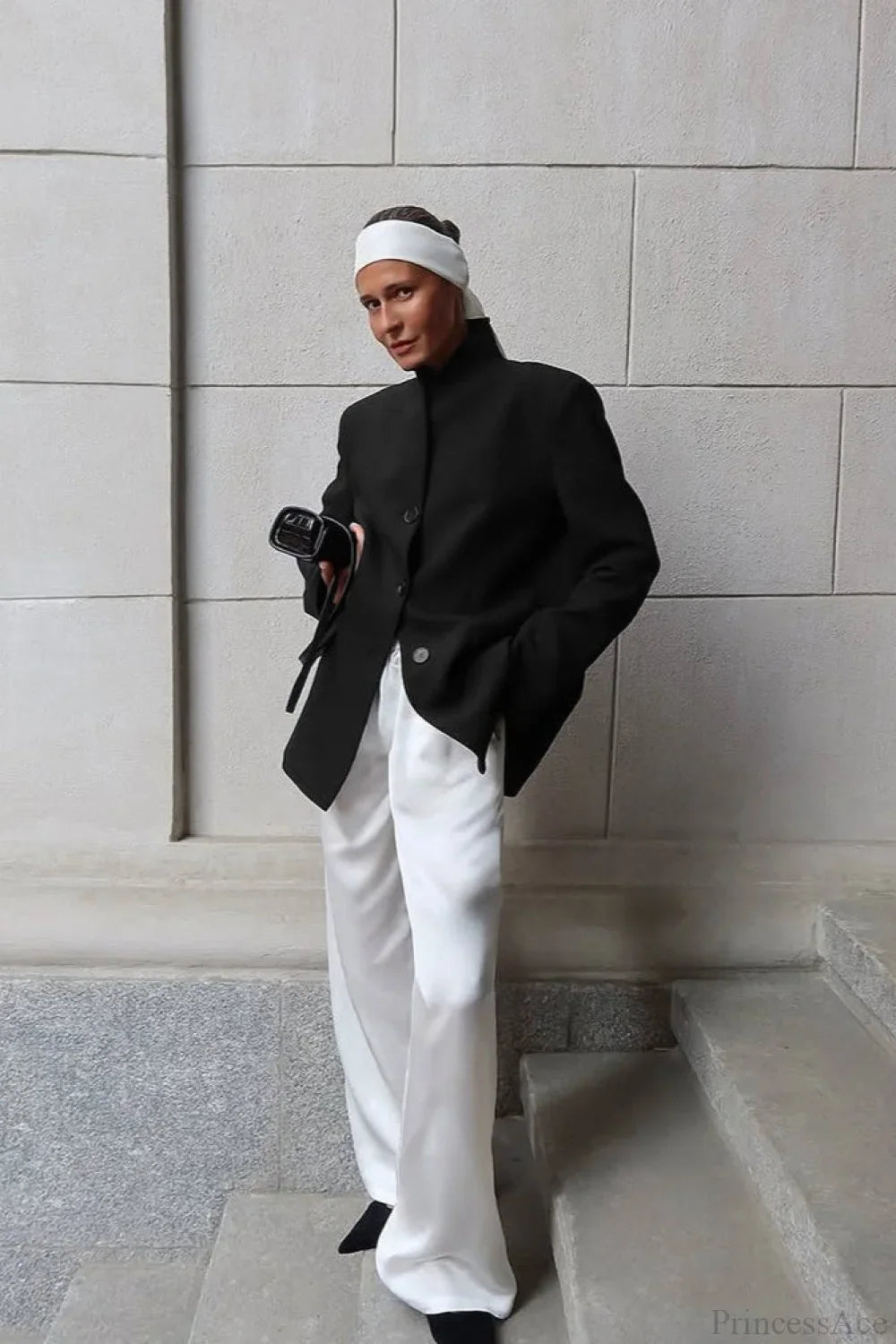 Aveline Black blazer styled full-length with wide-leg white pants and a white headband.