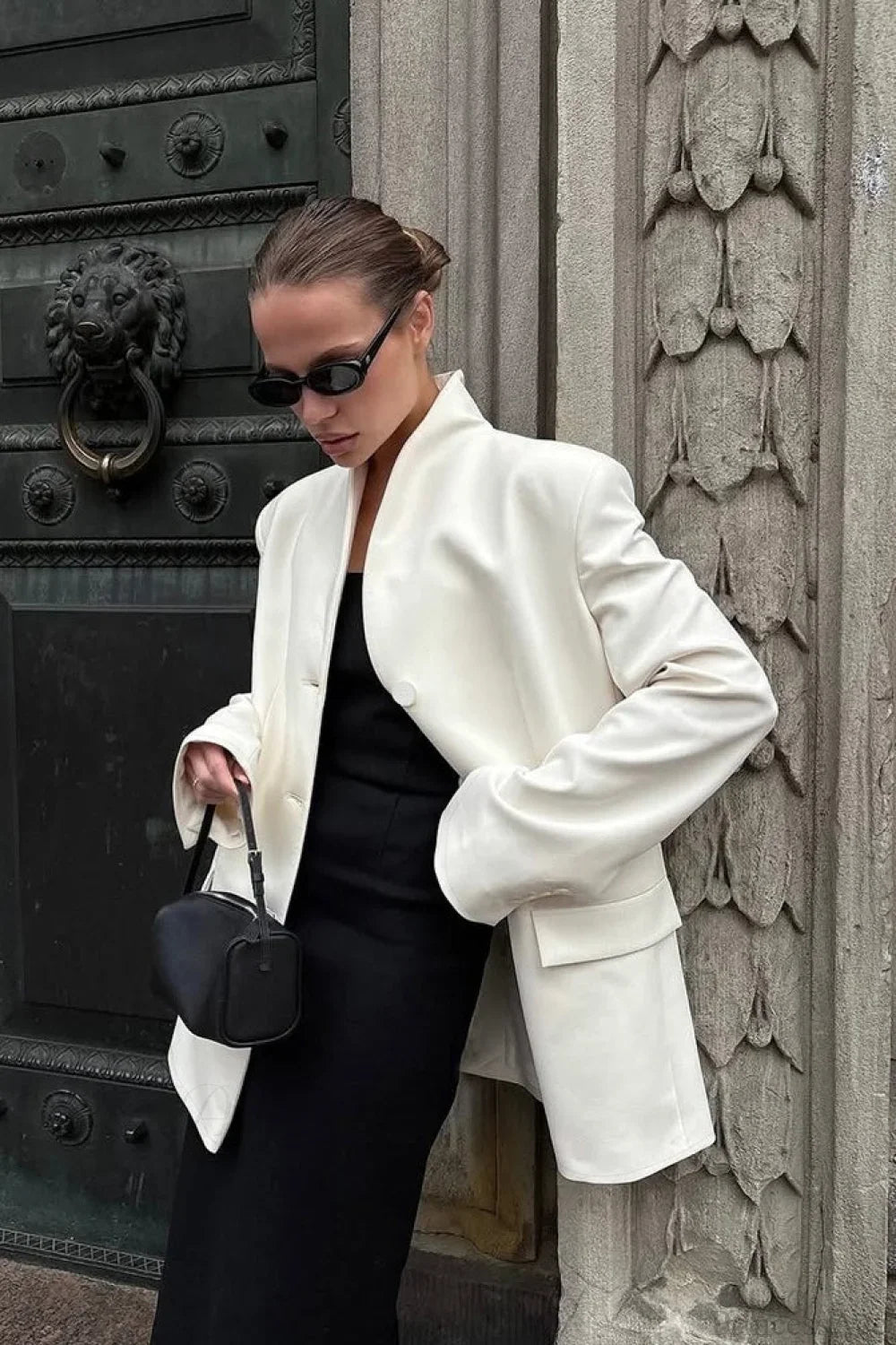 Aveline White blazer showing the stand collar, flap pocket, and relaxed sleeves.
