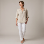 Front view of the Averil Blouse Linen Long-Sleeve in beige, featuring a split V-neckline, long rolled sleeves, button detail, and a relaxed lightweight linen silhouette. Designed by Bella Hudson.