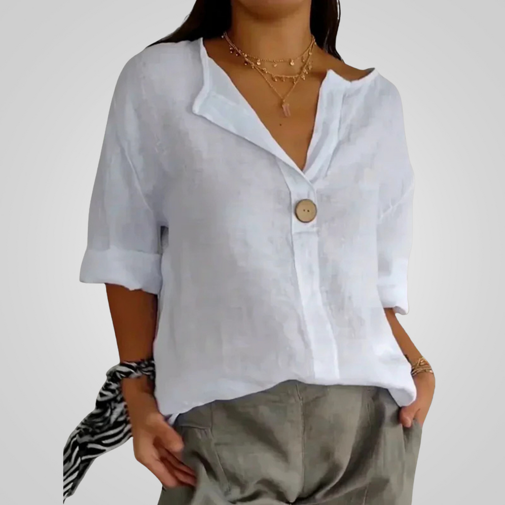 Front view of the Averil Blouse Linen Long-Sleeve in white, featuring a split V-neckline, long rolled sleeves, decorative button detail, and a breathable linen design. Designed by Bella Hudson.