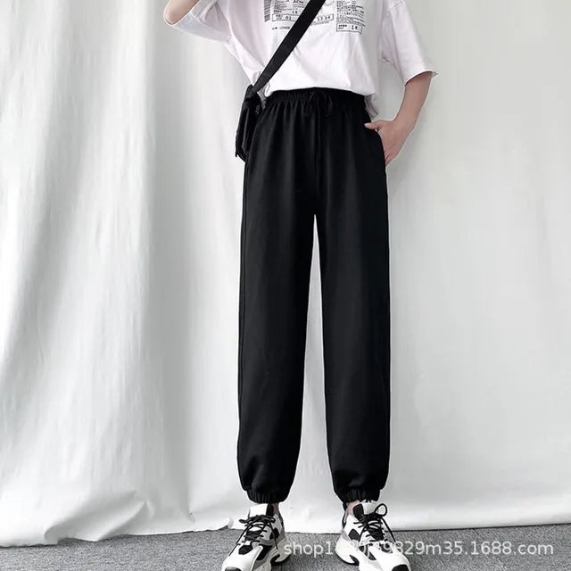 Avery Black fleece-lined jogger pants with elastic waistband, adjustable drawstring, relaxed fit, side pockets, and elastic ankle cuffs