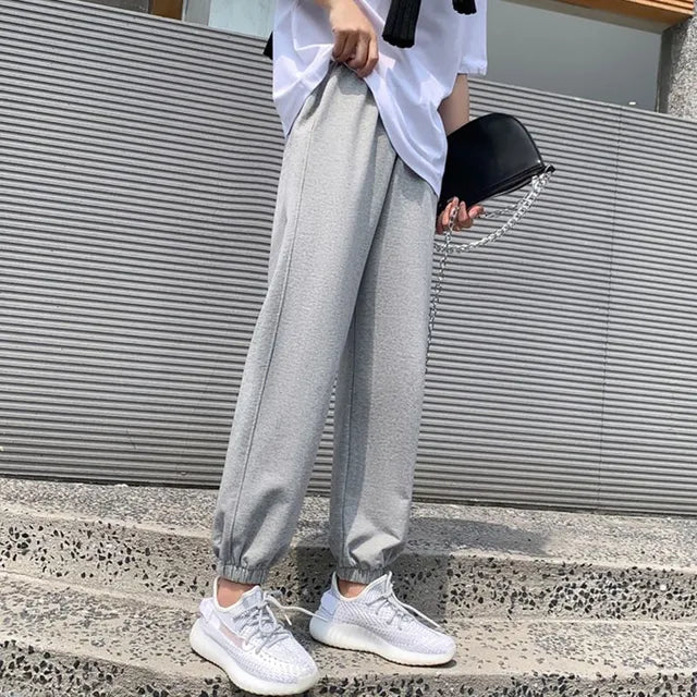 Avery Gray high-waisted jogger pants with relaxed legs, adjustable drawstring waistband, side pockets, and elastic ankle cuffs