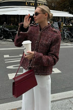 Avery Red tweed-textured cropped jacket styled outdoors with a structured silhouette, fringed edges, and cropped length