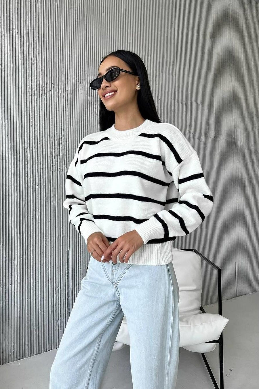 Avery White striped crew-neck sweater shown in a full-body view with a relaxed silhouette, horizontal stripe detailing, and long sleeves