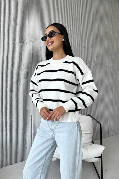 Avery White striped crew-neck sweater shown in a full-body view with a relaxed silhouette, horizontal stripe detailing, and long sleeves