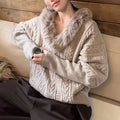 Beige cable-knit sweater with plush faux fur collar, long sleeves, and ribbed cuffs, shown in front view