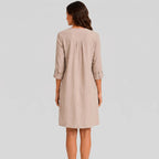 Back view of beige linen midi dress with rolled sleeves and side pockets by BELLA HUDSON