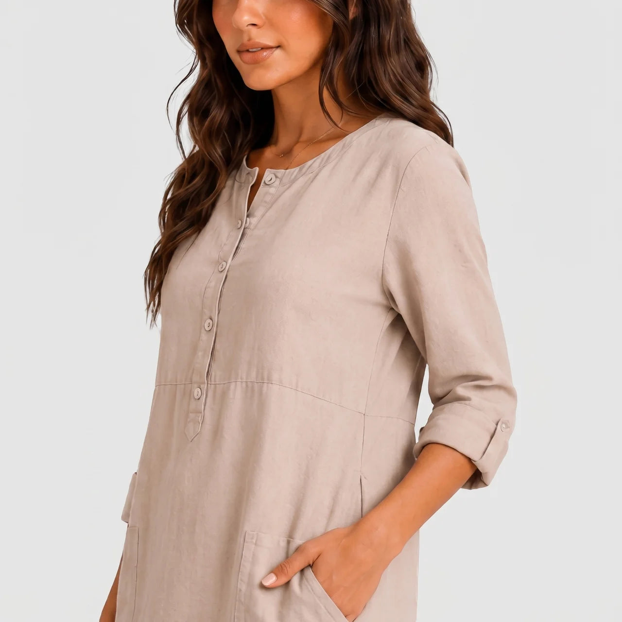 Close-up view of beige linen midi dress with rolled sleeves and side pockets by BELLA HUDSON