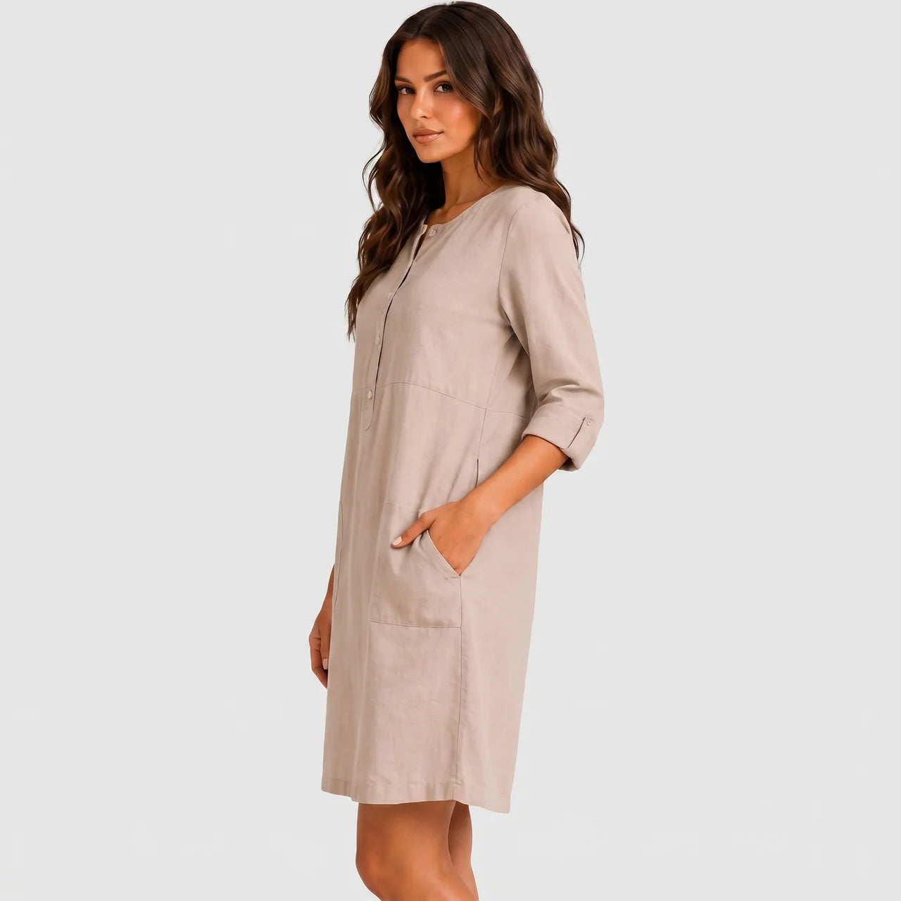 Side view of beige linen midi dress with rolled sleeves and side pockets by BELLA HUDSON