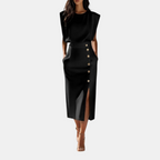 Front view of the Bella Women's Midi Dress in black, featuring a sleeveless design, cinched waist, decorative side buttons, and an elegant side slit. Designed by Bella Hudson.