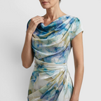 Close-up detail of the Bianca Midi Lightweight Dress Watercolor-Print Cowl-Neck in sky blue, featuring the draped cowl neckline, cap sleeves, lightweight fabric, and watercolor floral print. Designed by Bella Hudson.