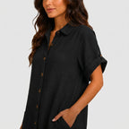 Close-up view of black button front midi dress with short sleeves and side pockets by BELLA HUDSON